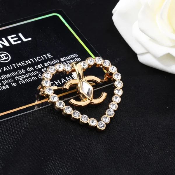 Replica Chanel Border set with diamonds and large gemstones CC brooch